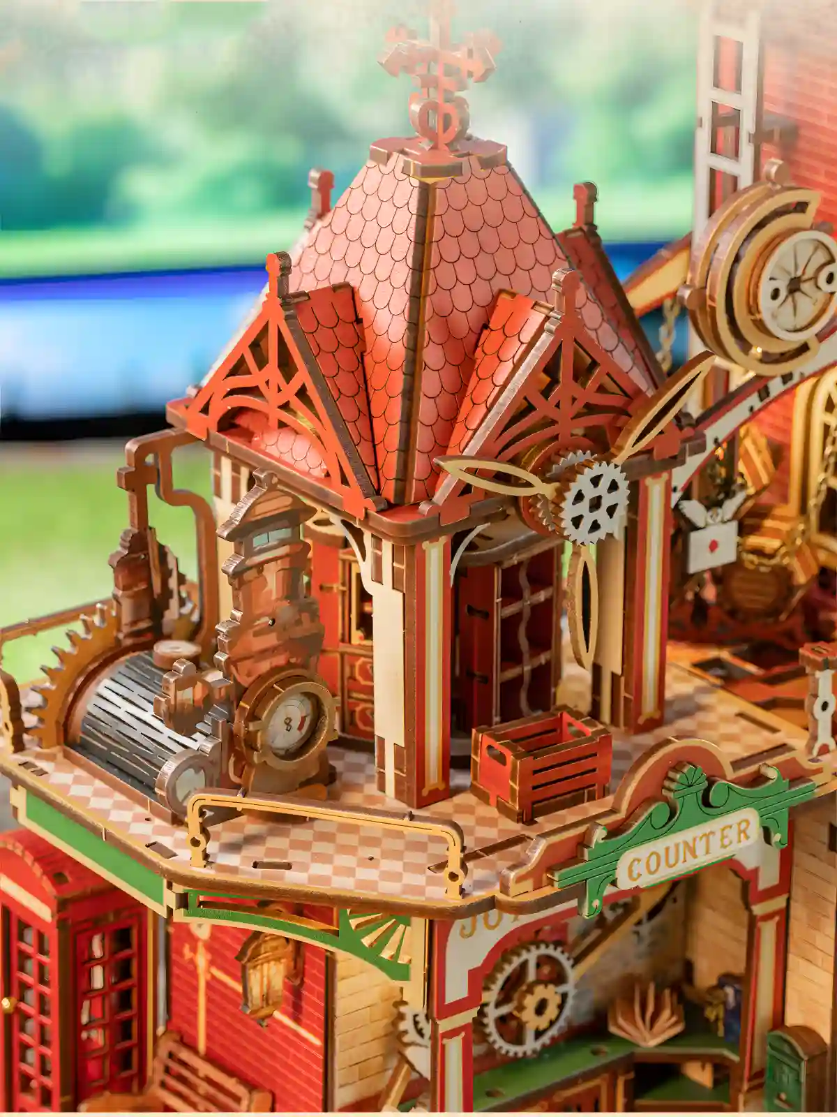 Architectural wooden model showing delicate rooftop carvings and vintage post office counter details.