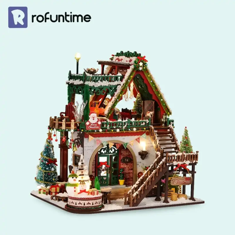 Snowy Christmas Lodge miniature house with LED lights, snow accents, and festive Christmas village display.