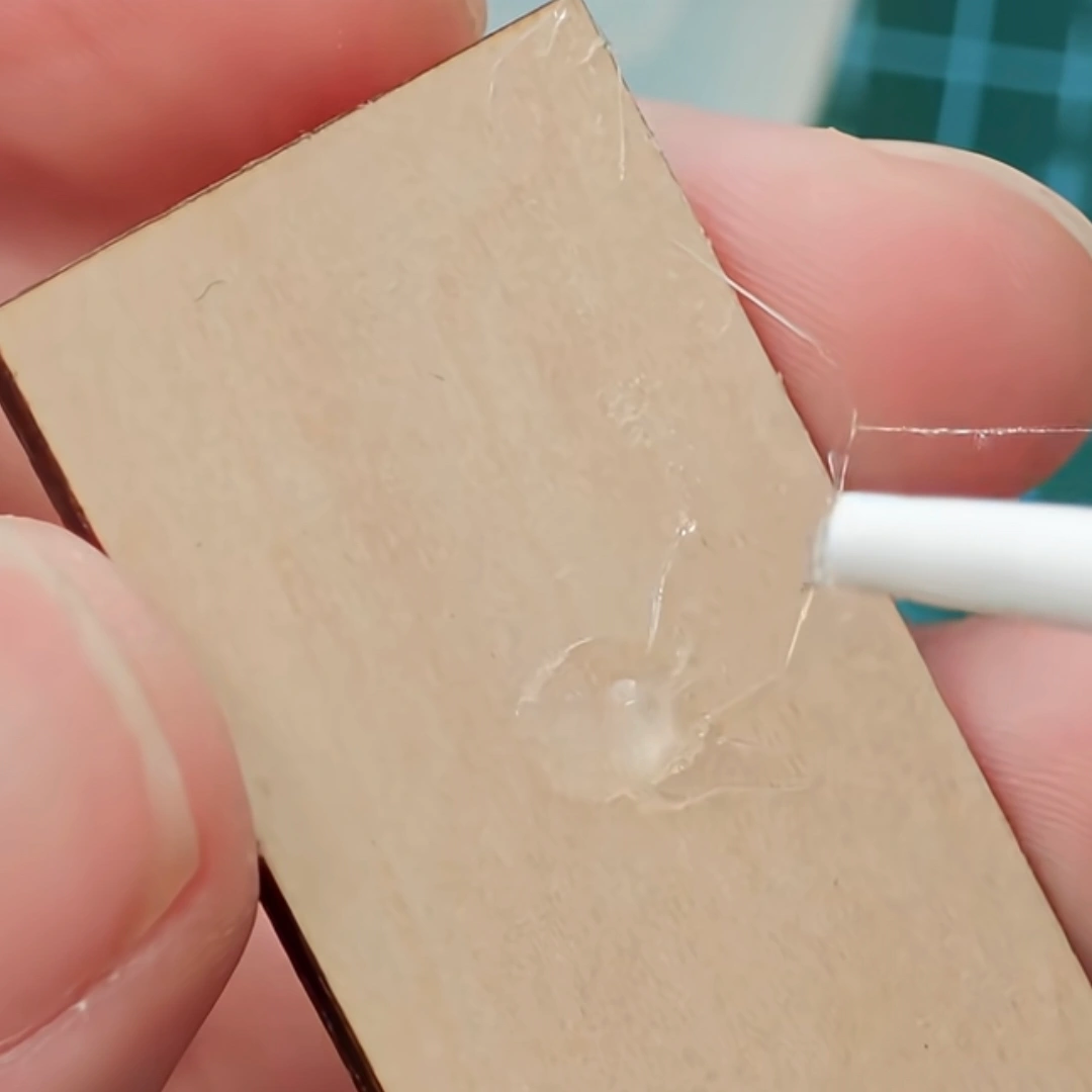 How to glue miniature pieces showing adhesive application to prevent glue strings
