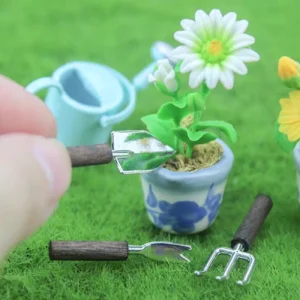 Miniature gardening tools set with miniature watering can and miniature potted plants for garden craft.