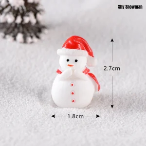 Adorable shy miniature snowman figurine in red hat for themed miniature scene crafting