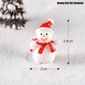 Friendly waving miniature snowman with red hat and candy cane for holiday crafts