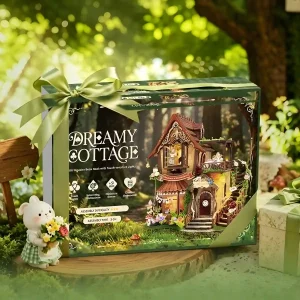 Dreamy Cottage DIY Book Nook Kit green gift box packaging with ribbon in garden setting.
