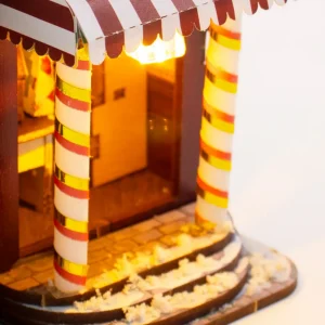 Red and white striped awning with candy cane entrance columns on DIY Christmas cottage