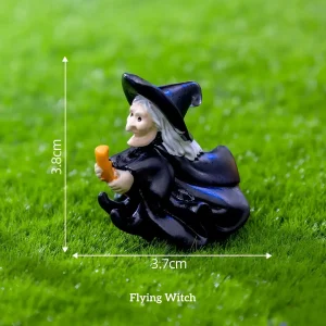 Hand-painted flying witch figurine miniature witch accessories on green grass background