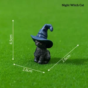 Black cat wearing blue wizard hat magical miniature decorations on grass