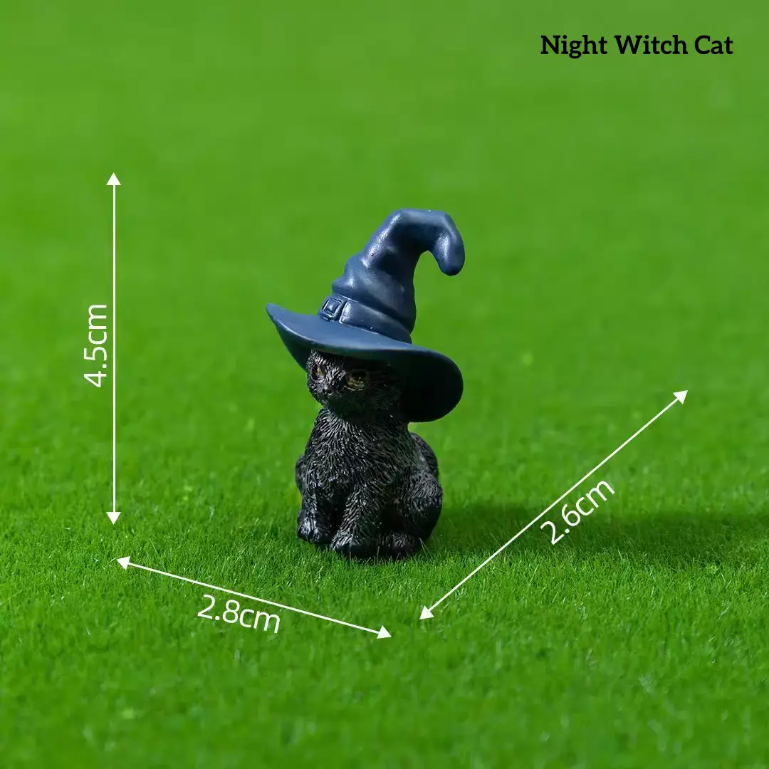 Black cat wearing blue wizard hat magical miniature decorations on grass