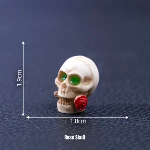Small skeleton skull holding red rose for Gothic Halloween miniature decorations