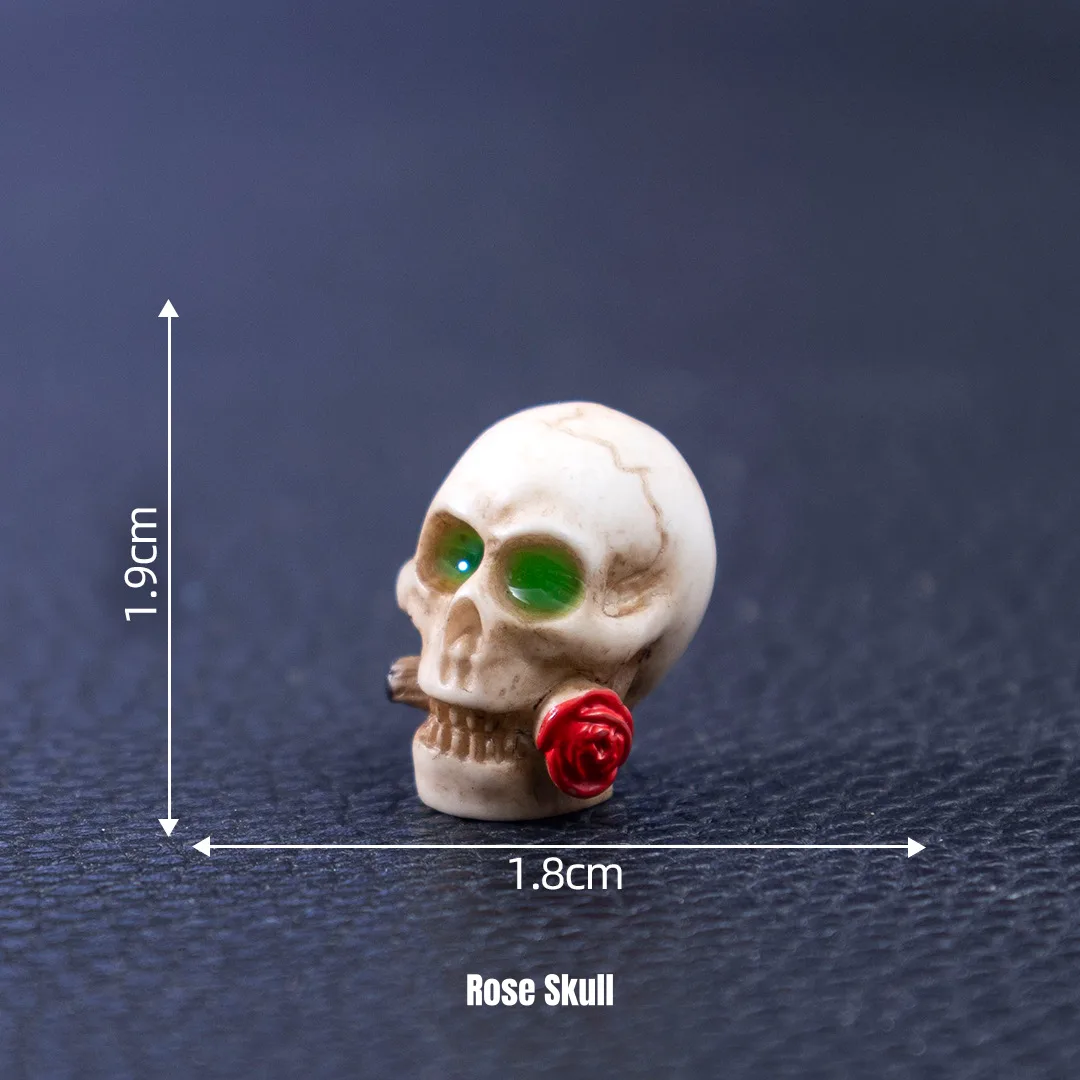 Small skeleton skull holding red rose for Gothic Halloween miniature decorations