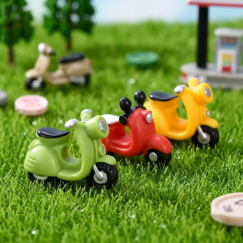 Colorful resin miniature motorcycle models displayed on grass for miniature street scene customization