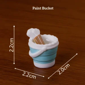 Blue paint bucket with brushes, practical miniature art supplies for DIY book nook accessories.