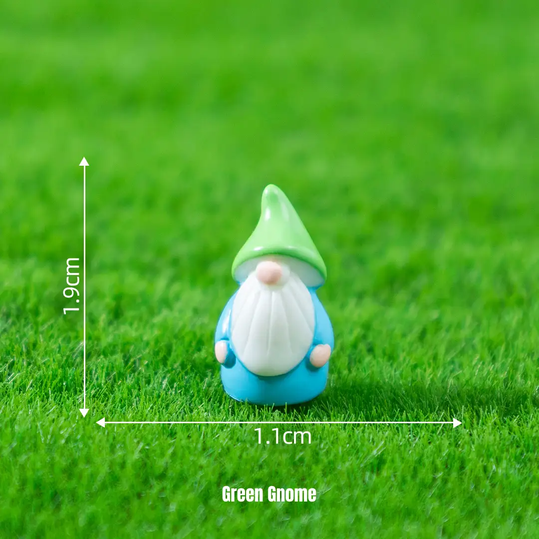 Tiny gnome miniature fairy characters with pointed green hat on artificial grass