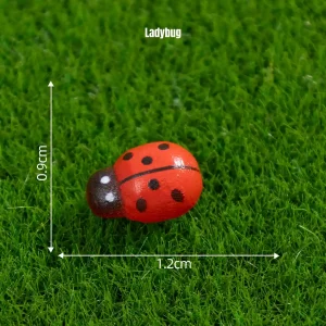 Red ladybug miniature decorations piece on green grass for fairy garden scenes