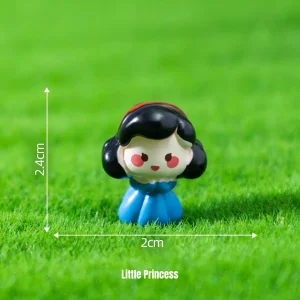 Cute princess miniature characters in blue dress on green grass for fairytale scene accessories