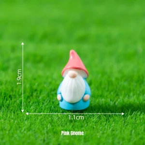 Cute gnome miniature decorations with pink cap on grass for themed miniature scene setups