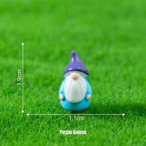 Small gnome miniature figurines with purple hat on grass for fairytale garden scenes