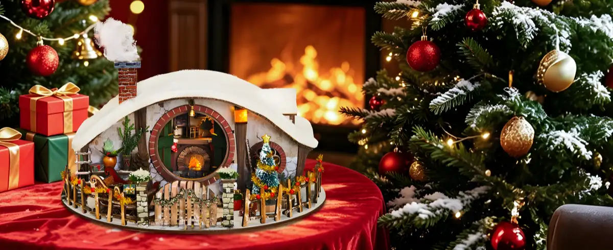 Illuminated Christmas miniature house kit displayed near Christmas tree for festive DIY decor