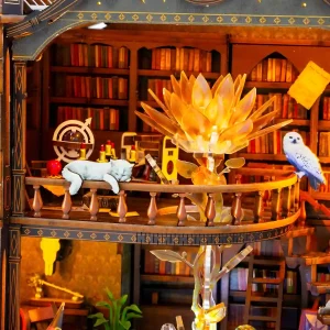Upper balcony of magical library miniature with rotating golden flower, owl, and cat